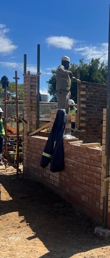 A bricklayer at work on a social infrastructure project.