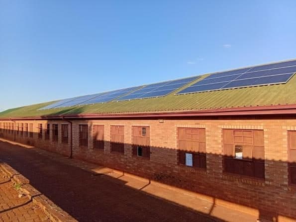 Solar panels installed across a school roof.